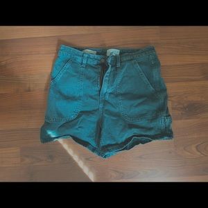 Emerald green high waisted shorts .